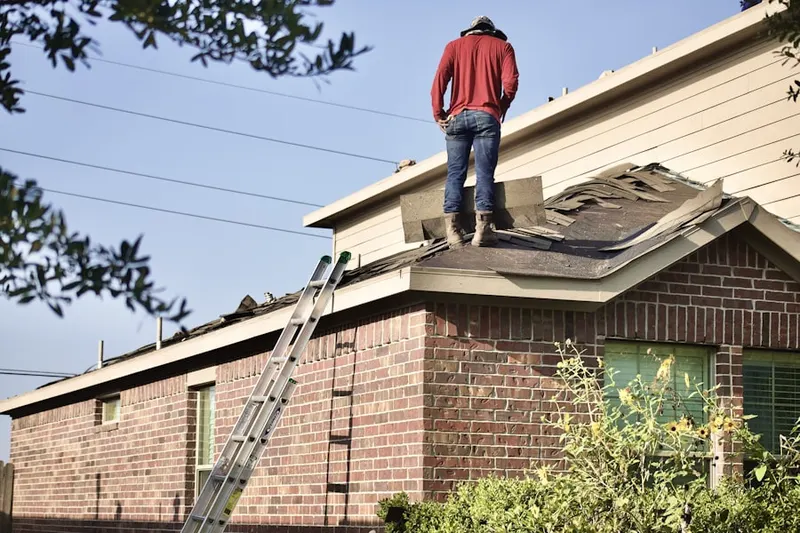 Professional roofer working on a residential roof in St. Albans